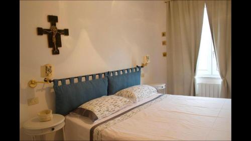 a bedroom with a cross on the wall and a bed at Casa Paradiso in Anacapri