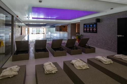 a hotel lobby with chairs and a purple ceiling at Mila apartmani Kopaonik in Kopaonik