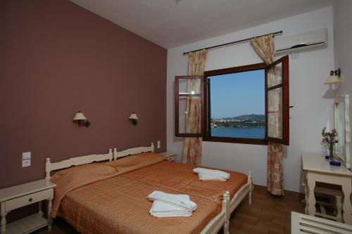 a bedroom with a bed with two towels on it at Villa Melia in Vassilias