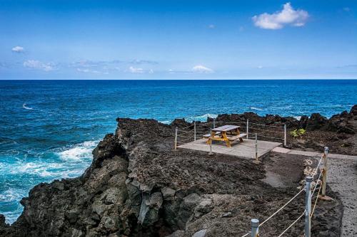 a picnic table on the edge of the ocean at Keauhou Kona Surf & Racquet Club #58 in Kailua-Kona