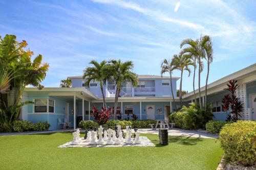 a large house with a chess board in the yard at St. Pete Beach Suites in St Pete Beach