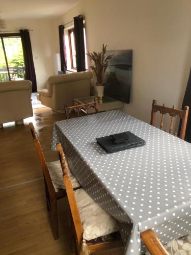 a dining room table with a black and white polka dot table cloth at Gwêl y Dŵr in Llanberis