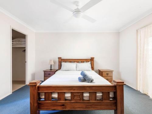 1 dormitorio con cama de madera en una habitación en Home away from home en Gerringong