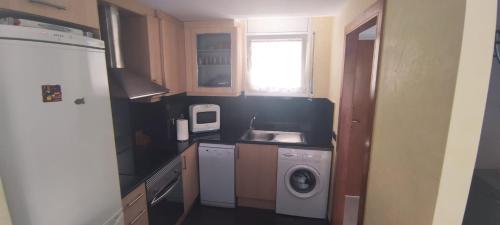 a small kitchen with a sink and a washing machine at Blanes Apartamento S'Abanell central park in Blanes