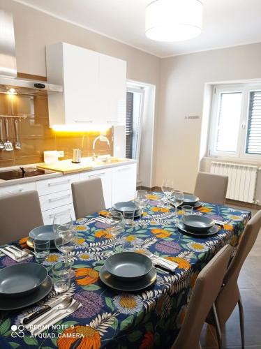 a dining room table with plates and glasses on it at La Carrozza sul Titerno in Faicchio