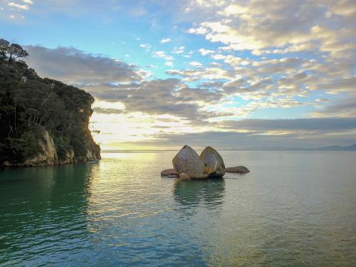 a group of large rocks in the water at Century Park in Nelson
