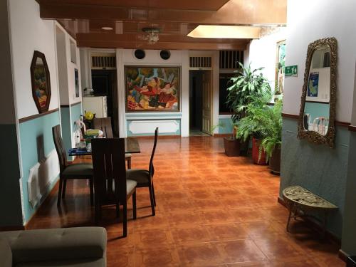 a dining room with a table and chairs in a room at HOTEL LA CASONA in Buga