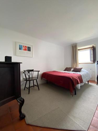 a bedroom with a bed and a table in it at Casa do Sétimo Passo in Marvão