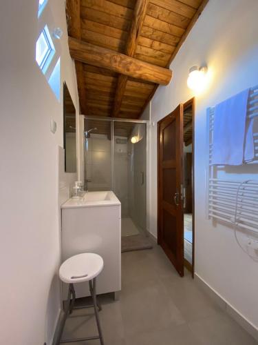 a bathroom with a toilet and a sink and a stool at Casa do Sétimo Passo in Marvão