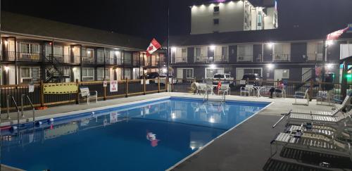 a pool at a hotel at night at Niagara Falls Courtside Inn in Niagara Falls