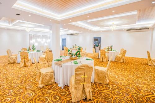 a banquet hall with two tables and chairs at Solano Hotel in Lipa