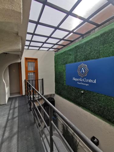 a hallway with a sign on the wall of a building at Alquería Central hotel in Tlaxco de Morelos