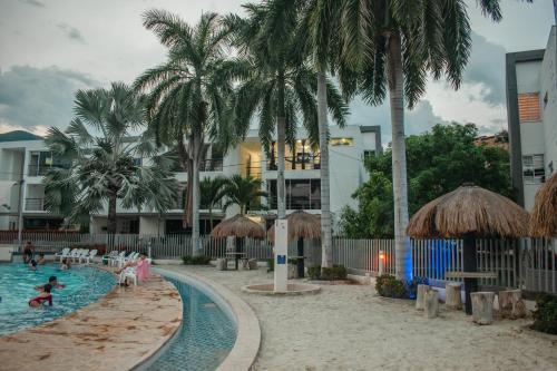 a pool at a resort with people playing in it at Apartasol santa fe de Antioquia in Santa Fe de Antioquia