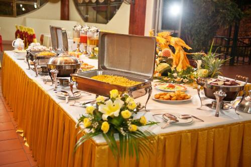 a buffet line with food on a table at Muong Thanh Lai Chau Hotel in Pan Linh