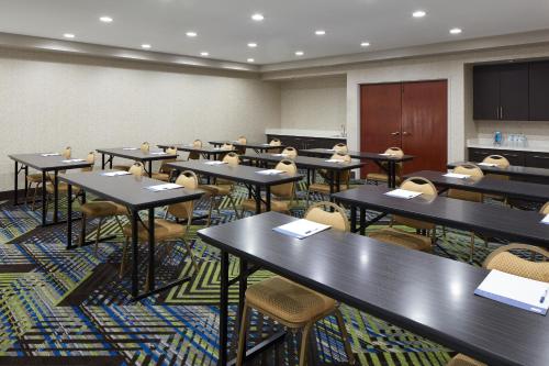 a classroom with rows of tables and chairs at Holiday Inn Express & Suites Asheville SW - Outlet Ctr Area by IHG in Asheville