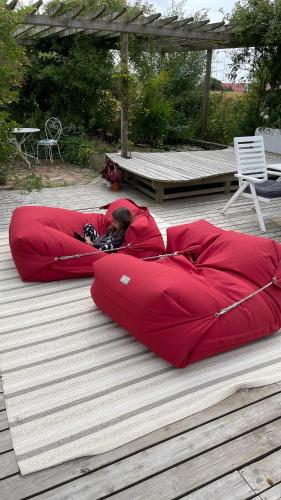 a person laying in a sleeping bag on the ground at Peppinge Bed & Breakfast in Löderup