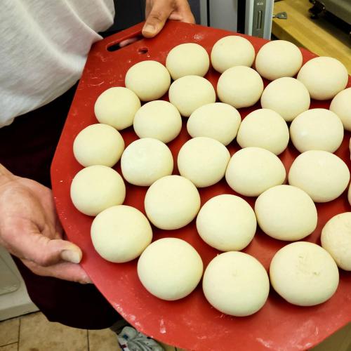 a man holding a red tray with white balls at Hotel Rotes Ross in Erlangen