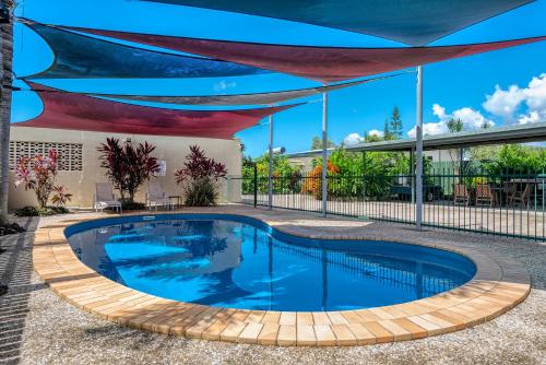a swimming pool with a canopy over it at Demi View Motel in Mossman