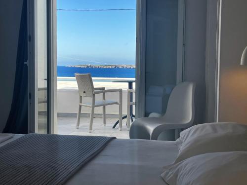 a bedroom with a bed and a view of the ocean at Villa Irini in Naousa