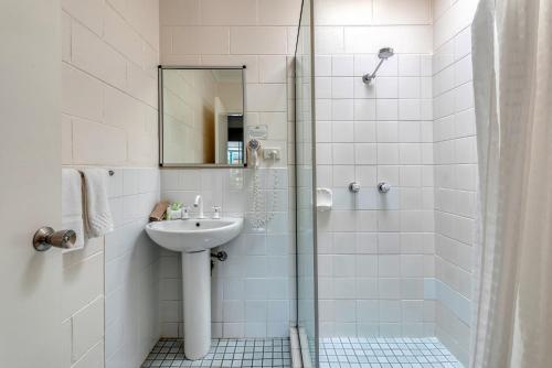 a bathroom with a sink and a shower at Demi View Motel in Mossman