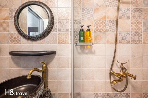 a bathroom with a shower with a sink and a mirror at Hope castle in Taitung City