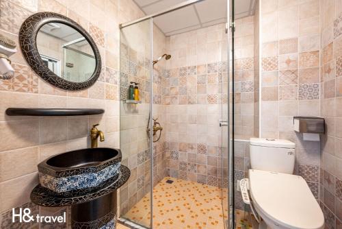 a bathroom with a shower with a toilet and a mirror at 希望城堡 l 全自助入住 in Taitung City