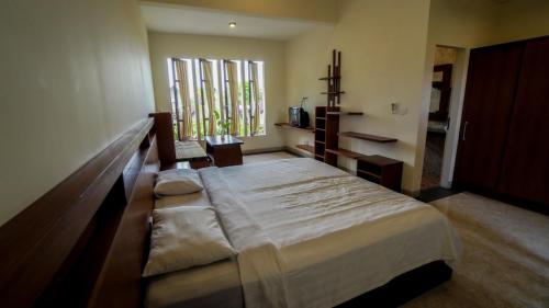 a bedroom with a large bed in a room at The Janan Villa in Sanur