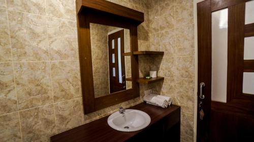 a bathroom with a sink and a mirror at The Janan Villa in Sanur