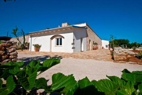 a house with a large driveway in front of it at Masseria Stellato in Nardò