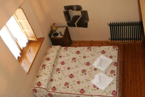 a bedroom with a bed with two towels on it at Casa Susarón in Puebla de Lillo