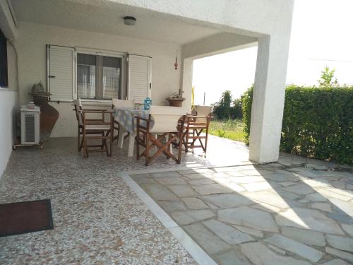 a patio with a table and chairs in a house at Ellina's Home - Euboea island Greece in Oxílithos