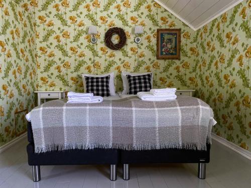 a bedroom with a bed with a blanket on it at Haaheim Gaard in Uggdal