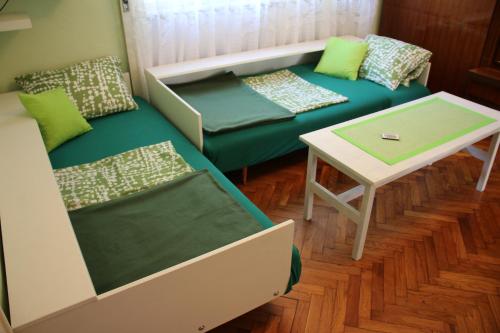 a living room with a couch and a table at Green Cactus Rooms - unique and cozy house in Senta