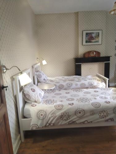 a bedroom with a bed with a white comforter at Villa Belle Epoque in Hamoir
