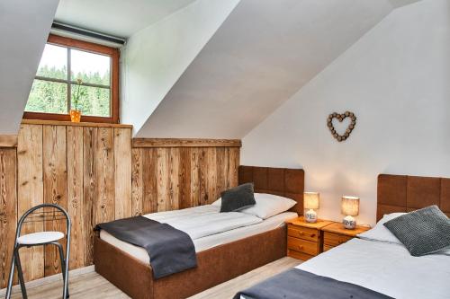 a bedroom with two beds and a window at Apartment Fuchswald in Lackenhof