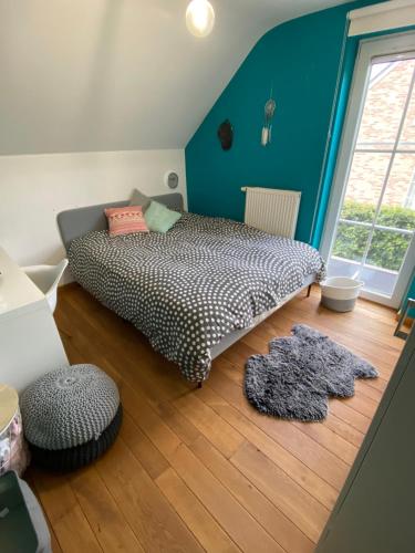 a bedroom with a bed and a wooden floor at BB La Marinière in Theux