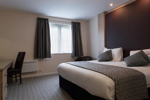 a hotel room with two beds and a window at Bannatyne Hotel Durham in Durham