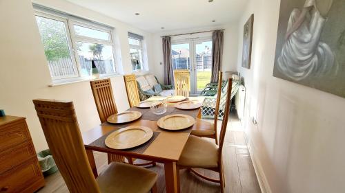 a dining room with a table with chairs at Airport Reach in Southend-on-Sea