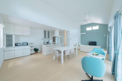a kitchen and dining room with a table and chairs at Villa Capri Miyakojima in Miyako-jima