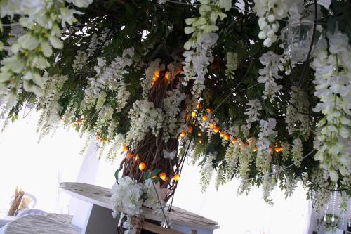 a bunch of white flowers hanging from a ceiling at Hotel Heaven in Rimini