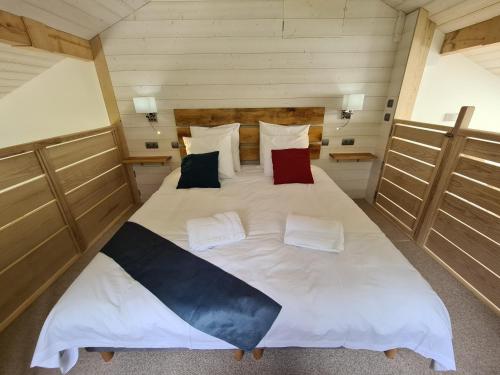 a large white bed in a room with wooden doors at Chalet Cristal Trail in Chamonix-Mont-Blanc