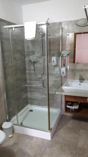 a bathroom with a shower and a sink at Penzión Dubo in Liptovský Mikuláš