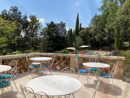 a group of tables and chairs on a patio at La Viste - SPA-JACUZZI - MASSAGE- SAUNA - 4 SAISONS - Piscine Chauffée Toute l'année - Heated POOL - 800m City Centre in Nyons