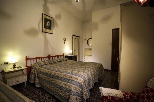 a bedroom with a bed with a striped blanket at Agriturismo il Poggetto in Torre