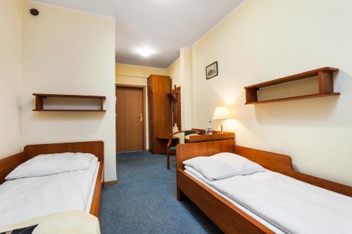En eller flere senge i et værelse på Hotel Olivia