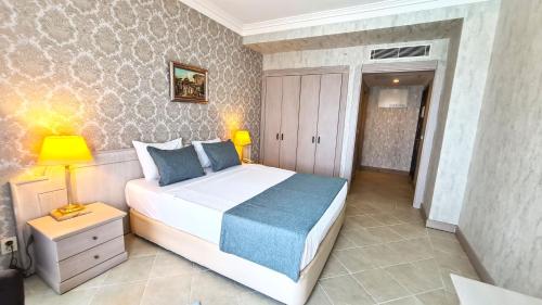 a bedroom with a large white bed in a room at X Life Hotel Sarıgerme 15 - Adult Hotel in Sarigerme