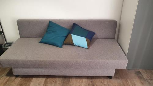 a couch with two pillows on it in a room at Hercules House - Il riposo degli Eroi in Ercolano