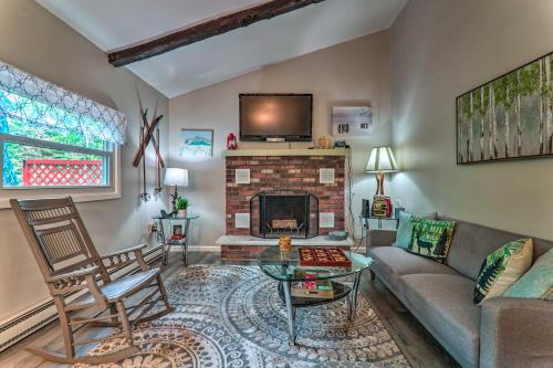 a living room with a couch and a fireplace at Fire Pit and Community Perks Blakeslee Cottage! in Blakeslee