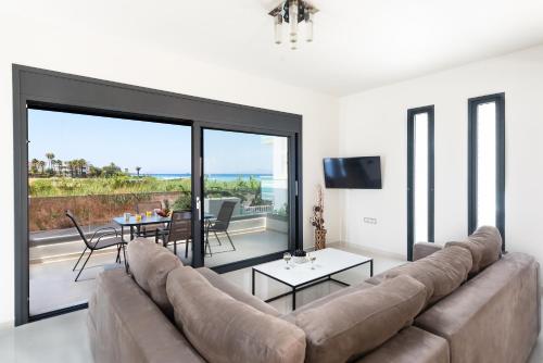 a living room with a large couch and a table at Ixia Breeze 3 in Ixia