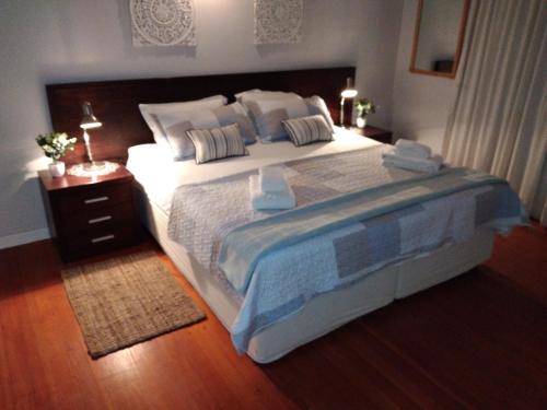 a bedroom with a large bed and a wooden floor at 20 on Beach Road in Swakopmund